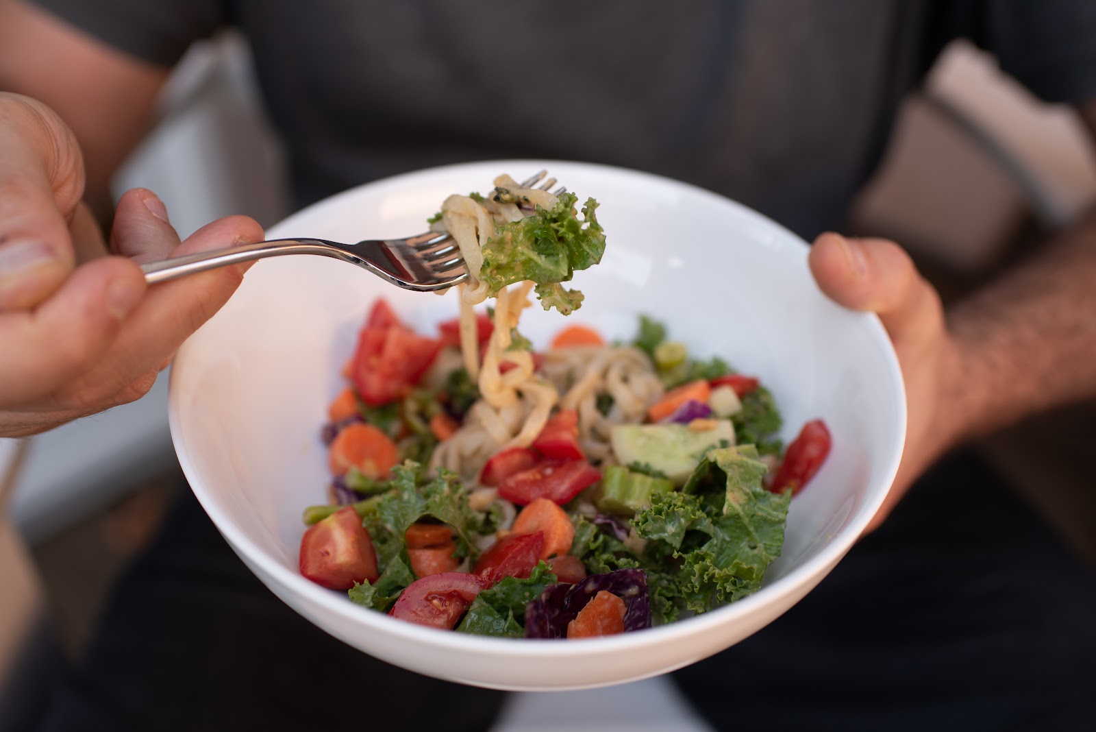 Hands preparing a fresh salad